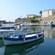 Fishing boats docked in a harbor next to a fortification wall
